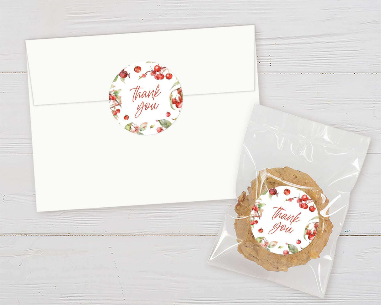 Apple-themed thank you stickers on envelope and cookie bag for baby shower favors