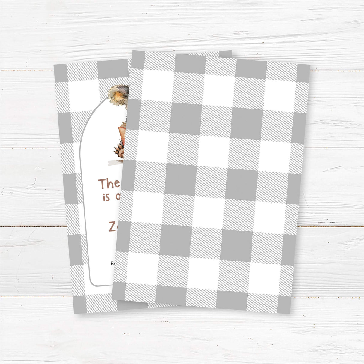 Book-themed baby shower invitation featuring a watercolor koala reading a red book, set against a neutral buffalo plaid background. Text reads "The Next Chapter is about to begin," with customizable event details. Perfect for literary or woodland-themed celebrations. back.