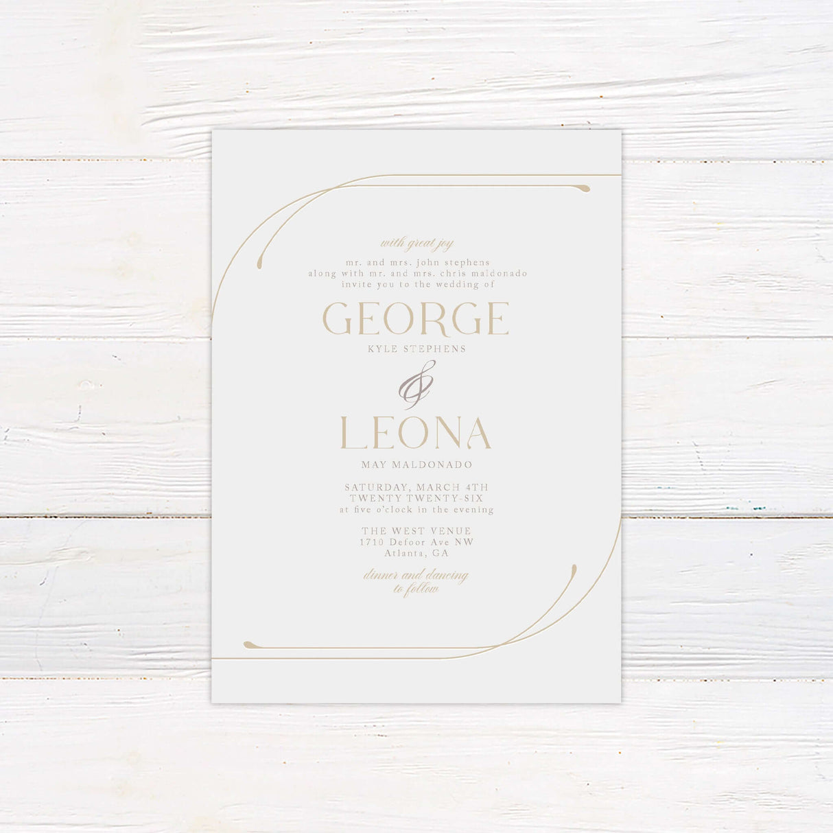 Modern minimalist wedding invitation printed on smooth white cardstock, featuring elegant serif typography and a delicate curved gold line accent wrapping around two corners. Designed for upscale, neutral-themed weddings, this printed invitation combines timeless design elements with refined simplicity. Ideal for contemporary or traditional couples seeking a clean, luxury wedding stationery suite with a soft, sophisticated aesthetic.