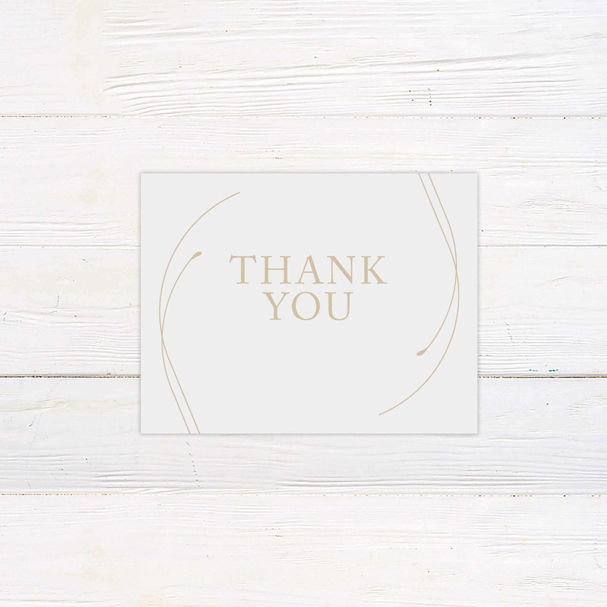 Minimalist thank you card printed on thick white cardstock with subtle gold curve linework at the corners and centered serif typography reading “Thank You.” Ideal for sending post-wedding gratitude to guests, this card maintains the cohesive elegance of the Timeless Curve wedding suite. With a blank or customizable interior, it balances simplicity and sophistication for couples looking for elegant, understated wedding stationery.