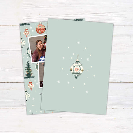 Christmas card with two family photos, vintage ornaments, trees, and snowflakes on a blue background with greeting: "Love, Joy, and Peace Today, Tomorrow, and Always" - back side