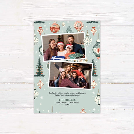 Christmas card with two family photos, vintage ornaments, trees, and snowflakes on a blue background with greeting: "Love, Joy, and Peace Today, Tomorrow, and Always"