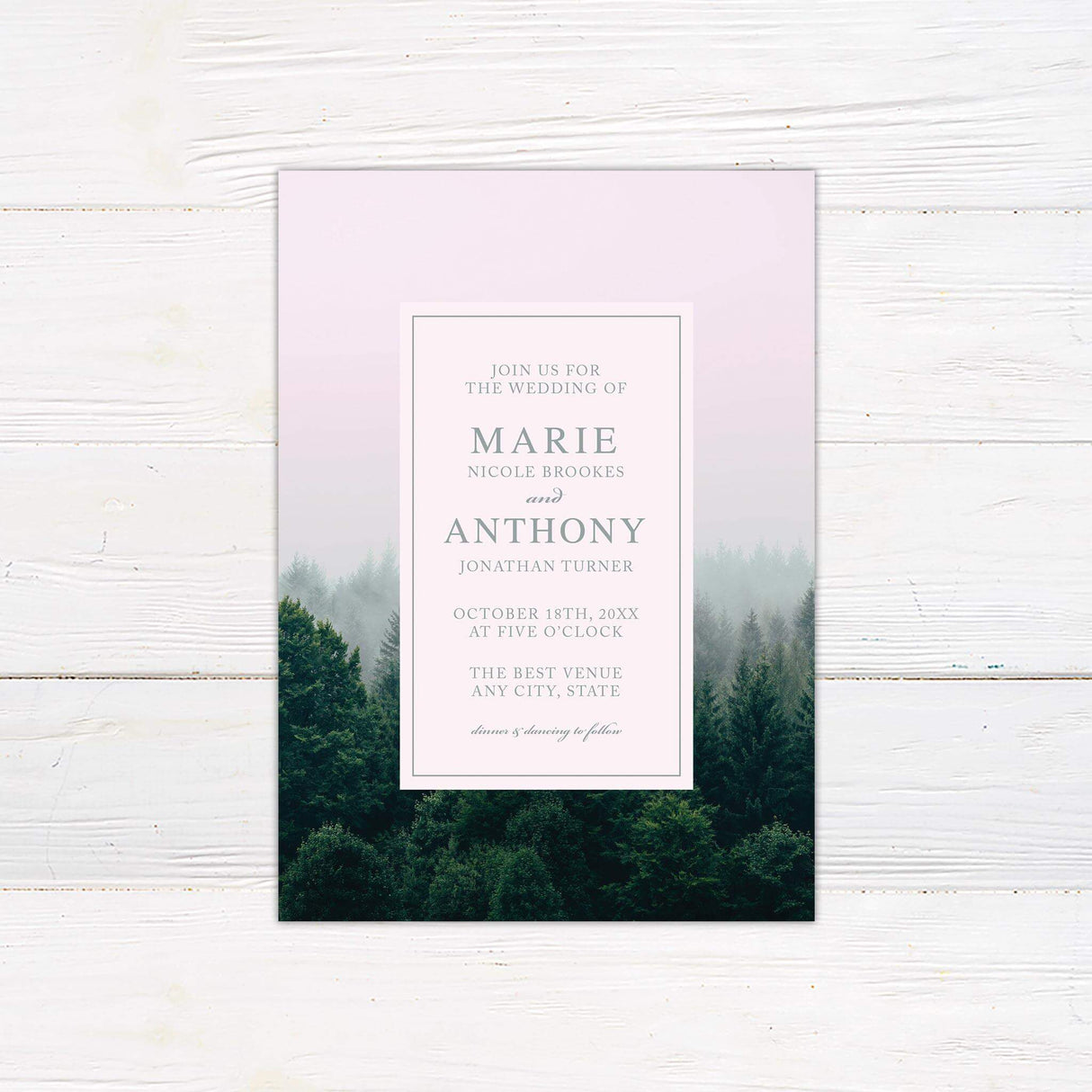 Wedding invitation featuring a misty treeline background with modern serif and script fonts, printed on premium cardstock.