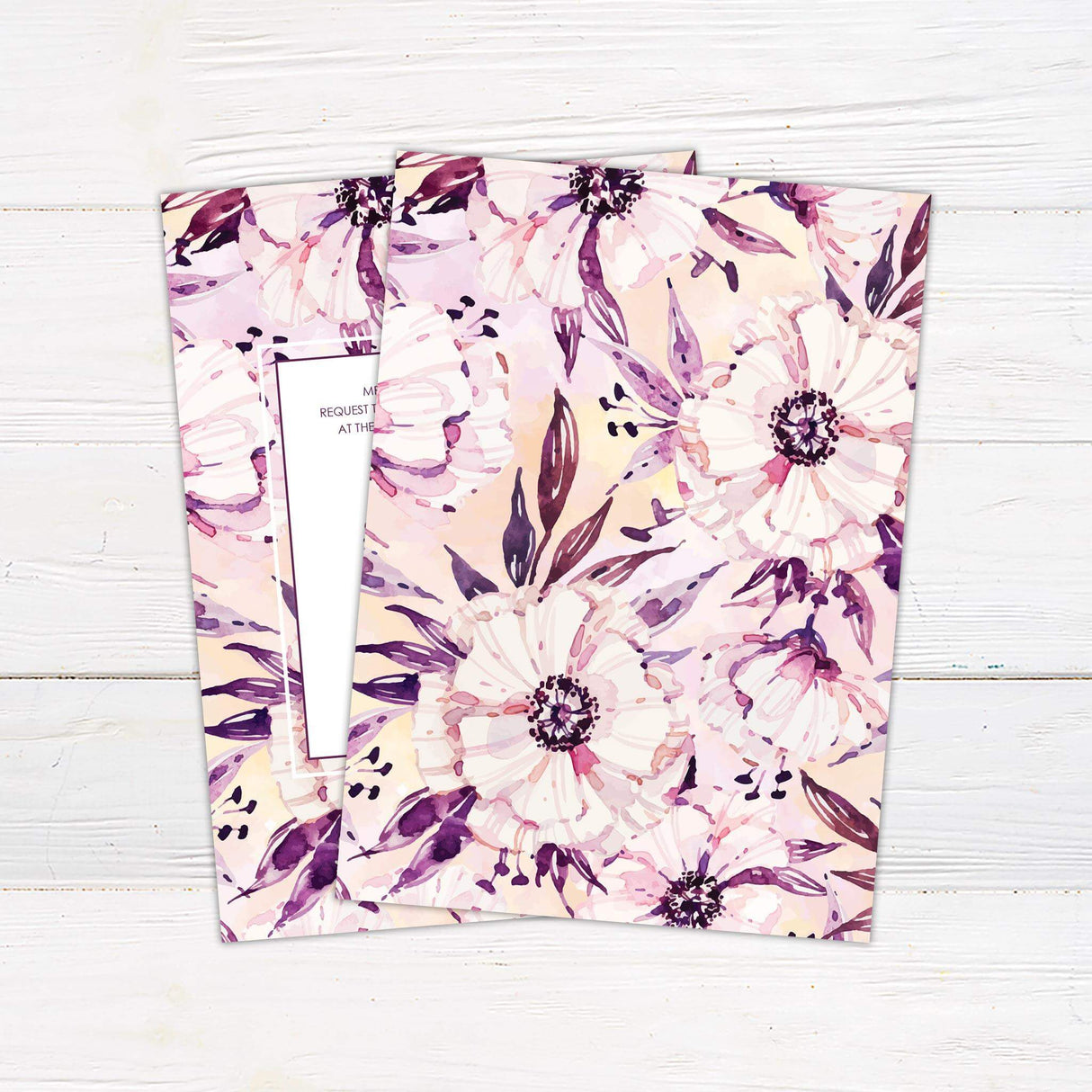 Watercolor floral wedding invitation with bold purple and blush blooms, white center panel, and elegant serif and script fonts.- back side