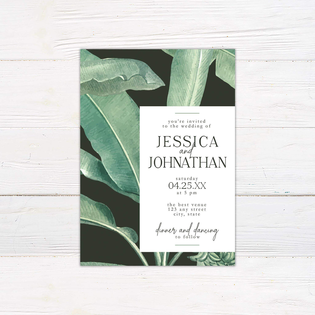 Wedding invitation featuring tropical green leaves on a dark background with a clean white panel and modern serif and script fonts.