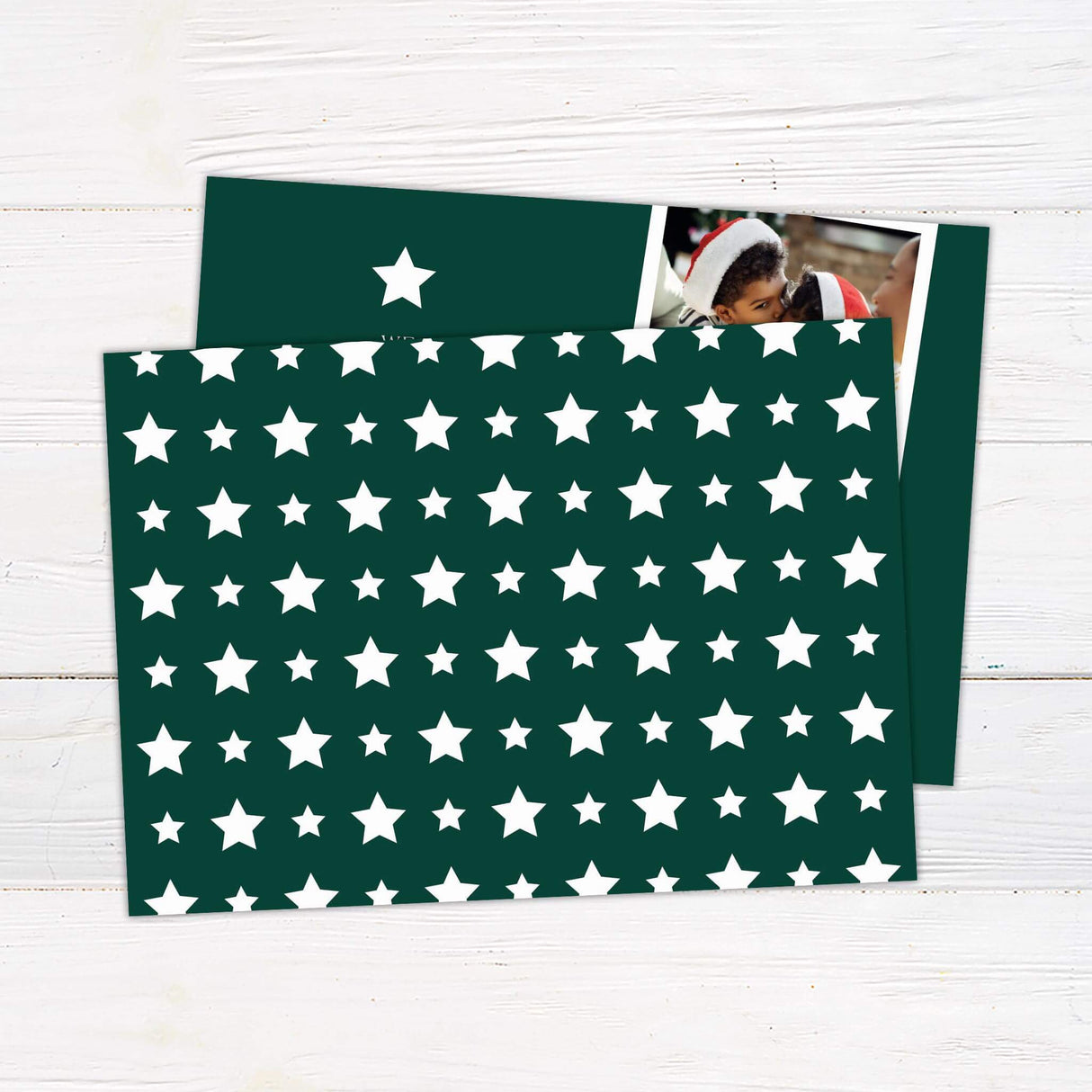 Two photo collage Christmas card with dark green background, white star accent, and personalized holiday greeting with family portraits. - back.