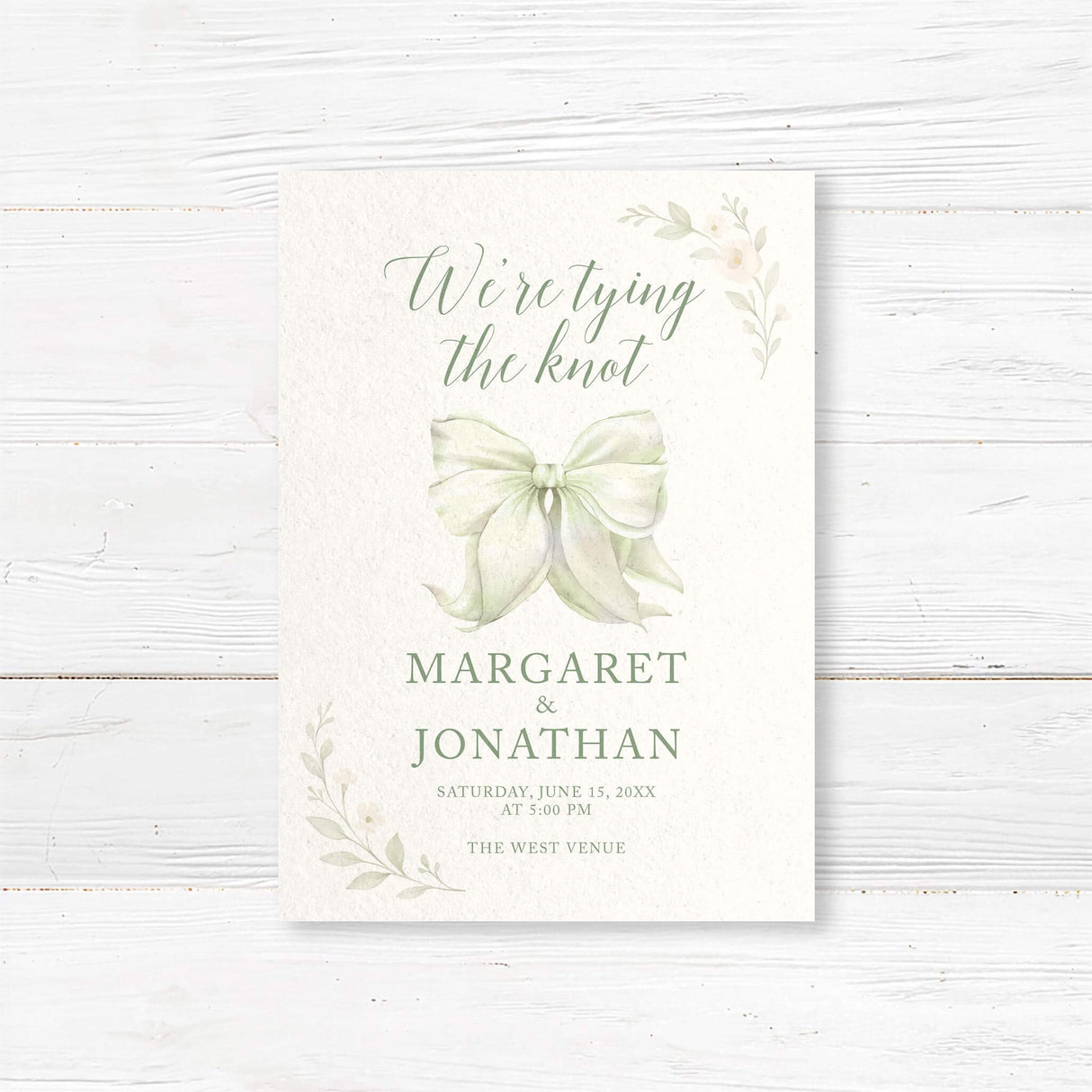 “Tying the Knot” wedding invitation with hand-painted bow and floral accents, professionally printed on textured cardstock