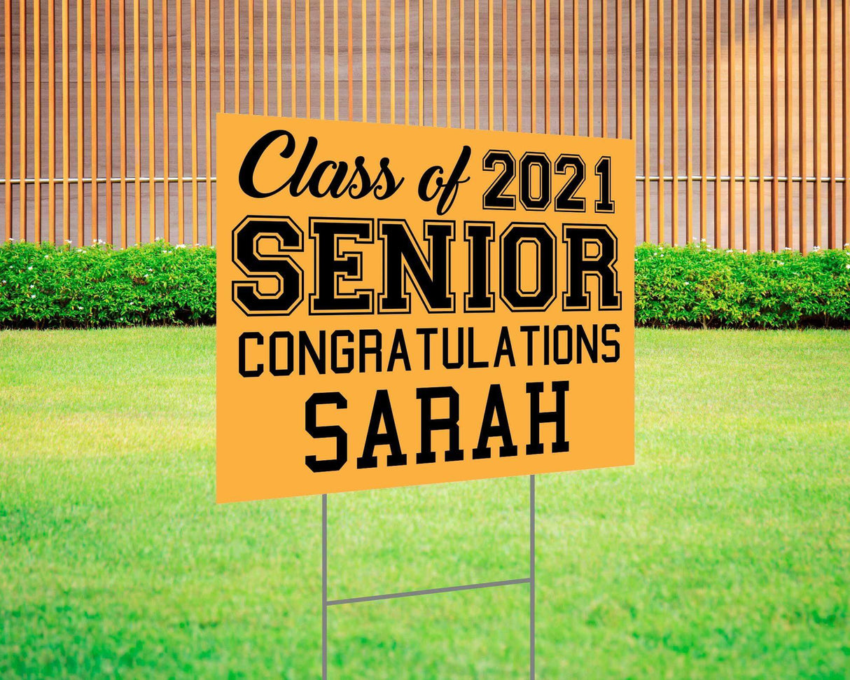 Graduation yard sign featuring bold varsity-style SENIOR lettering, custom class year, and congratulations message. Printed on durable Coreplast plastic, available in custom colors and single or double-sided print, perfect for high school and college graduates. Gold