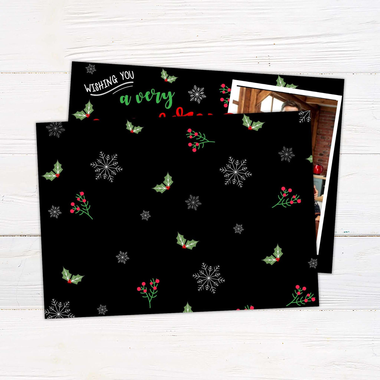 Very Merry Christmas card with black background, red and green festive lettering, three family photos, and personalized holiday greeting. - back.