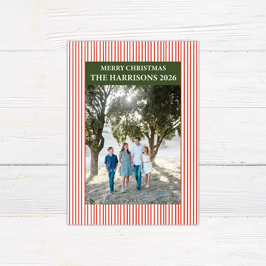 Personalized family Christmas photo card featuring a classic striped border, large family photograph, Merry Christmas greeting, and custom family name. The coordinating back features a decorated Christmas tree framed by matching pinstripes. red