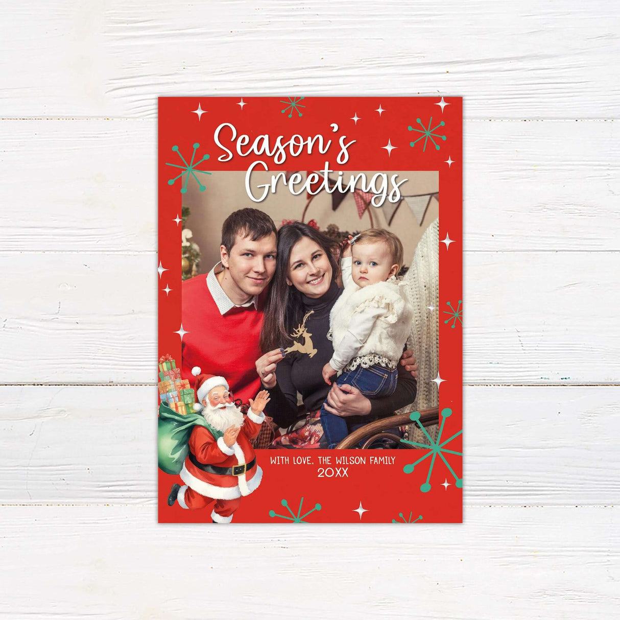 Season’s Greetings photo card with red background, vintage Santa illustration, retro starburst accents, and a family photo centered on the design.