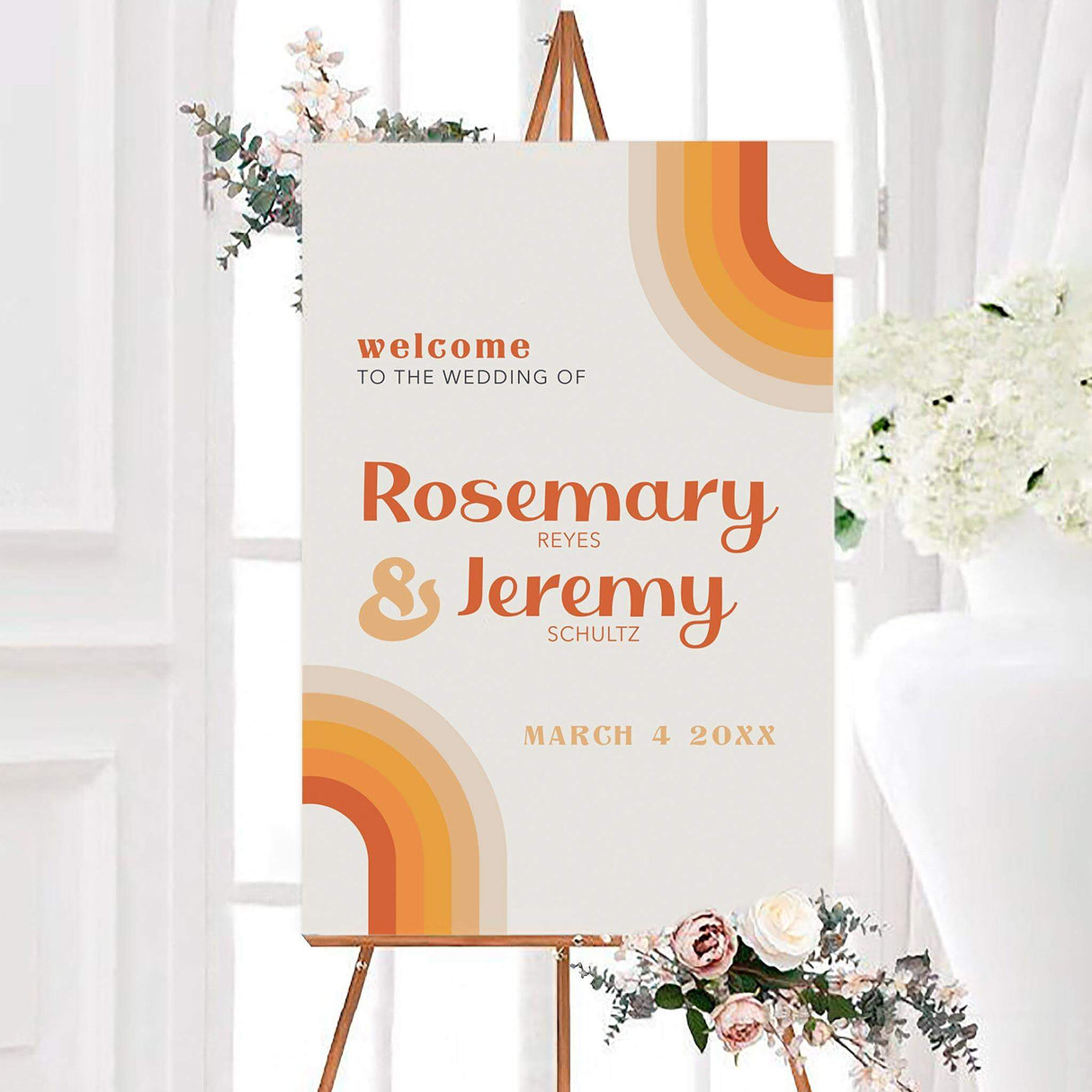 Vintage stripes wedding welcome sign featuring curved retro stripes in orange, gold, peach, tan, and cream. Personalized typography displays the couple’s first names, surnames, and wedding date.