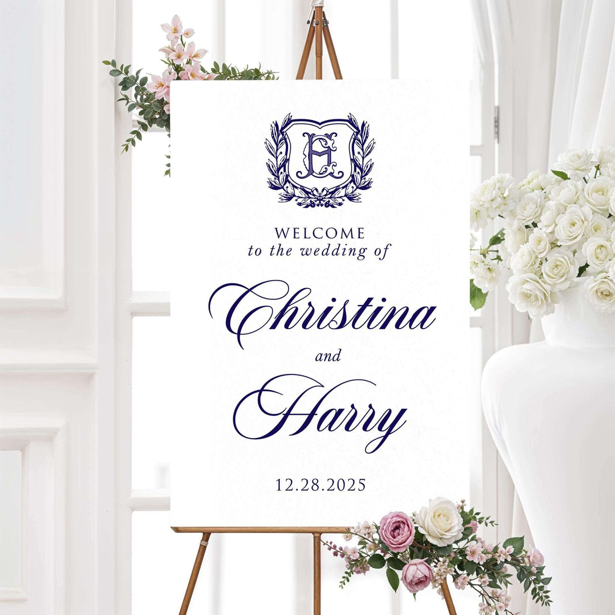 Wedding welcome sign with navy monogram crest and formal script for classic navy and white wedding theme
