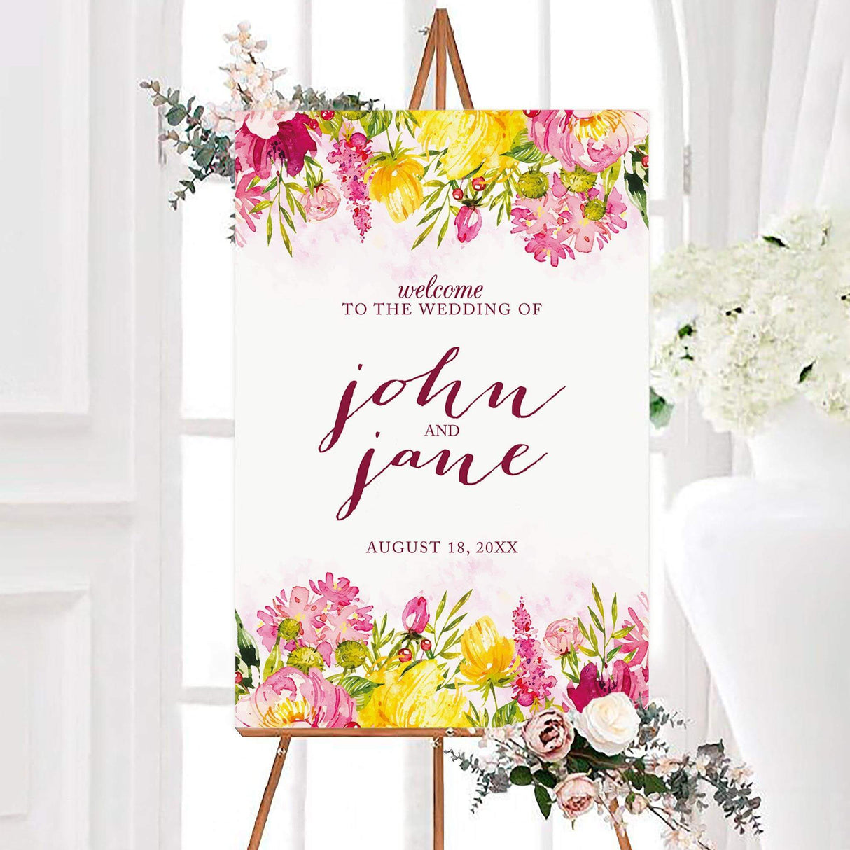 Modern welcome sign with deep pink and blush watercolor florals on the top and bottom of the sign wth mixed font design for text.