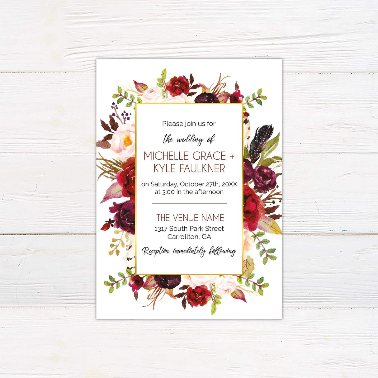 Wedding invitation with deep red, burgundy, blush, and ivory watercolor florals framing a white text box with modern script.