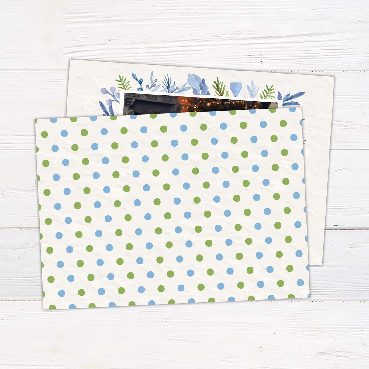 A holiday card with a family photo framed by watercolor greenery and leaves. The card includes a Merry Christmas message with customizable family name. - back.