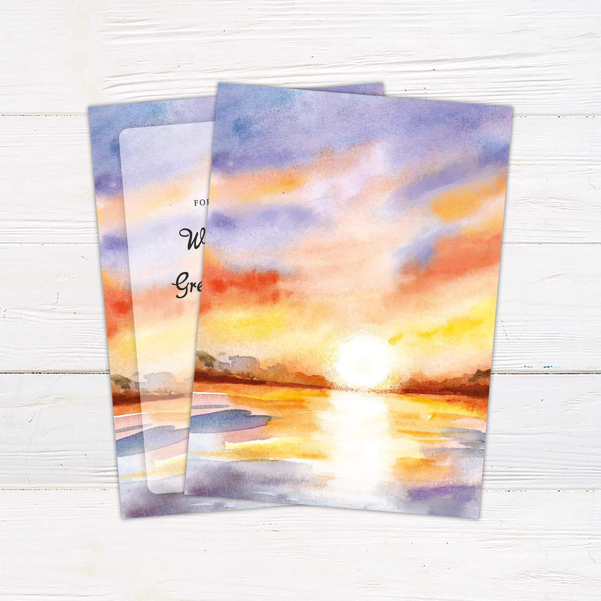 Romantic wedding invitation with watercolor lake and sunset sky in orange, purple, and pastel hues. Back.