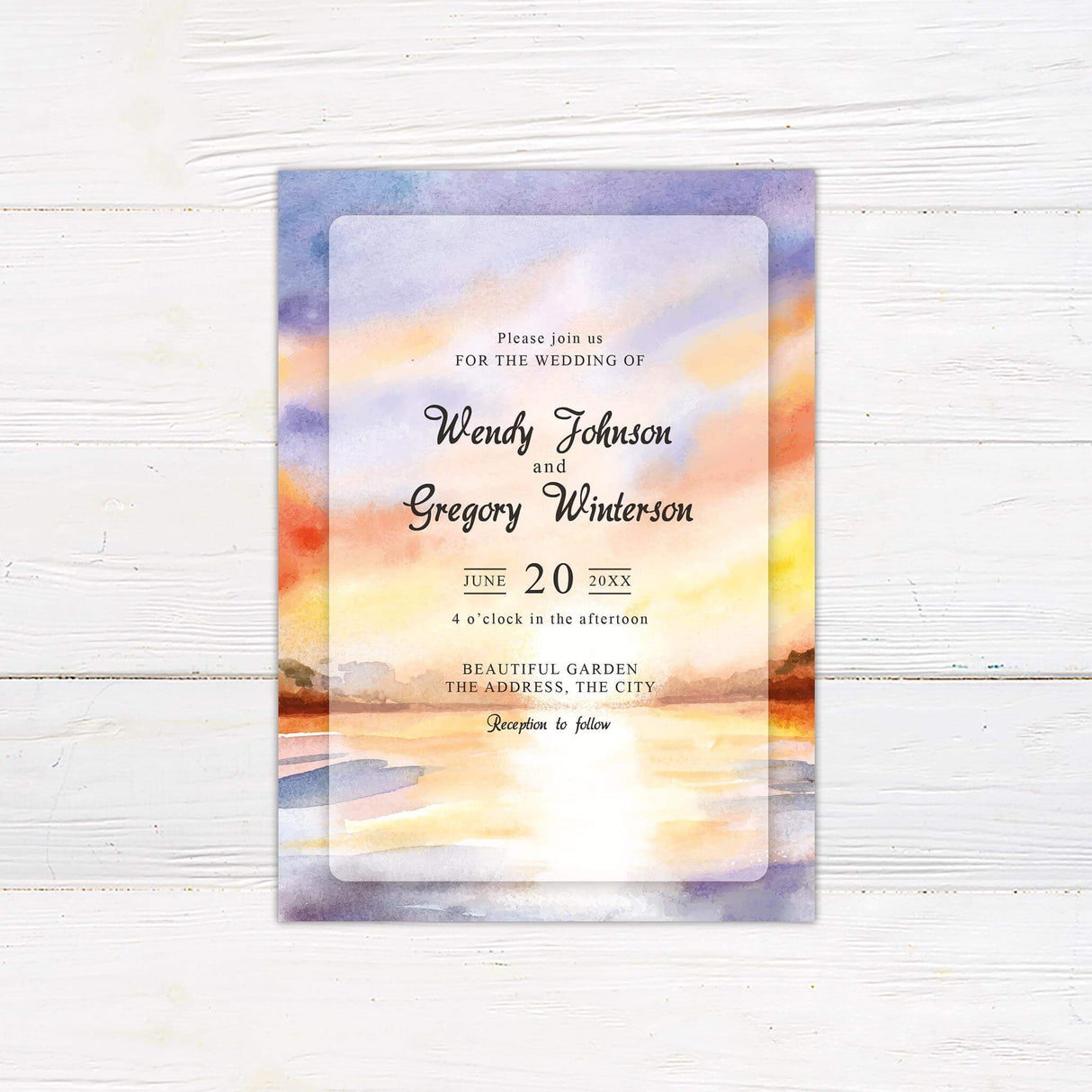 Romantic wedding invitation with watercolor lake and sunset sky in orange, purple, and pastel hues.