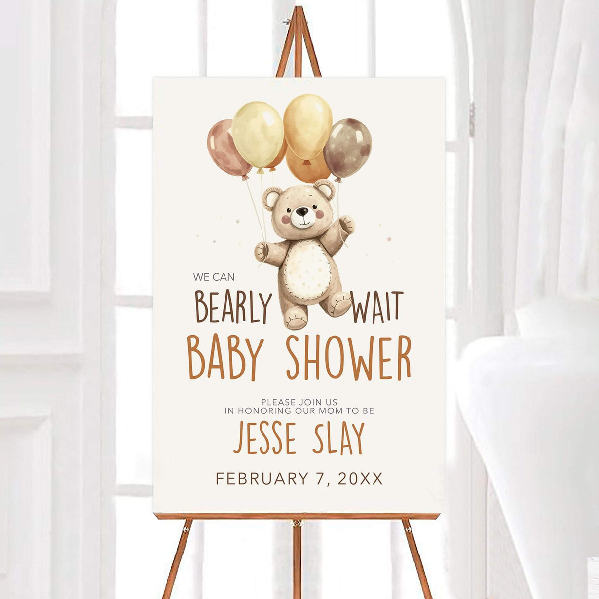"We Can Bearly Wait" baby shower welcome sign featuring a cute teddy bear holding balloons. The sign includes event details with warm brown and beige tones, set on an easel for display.