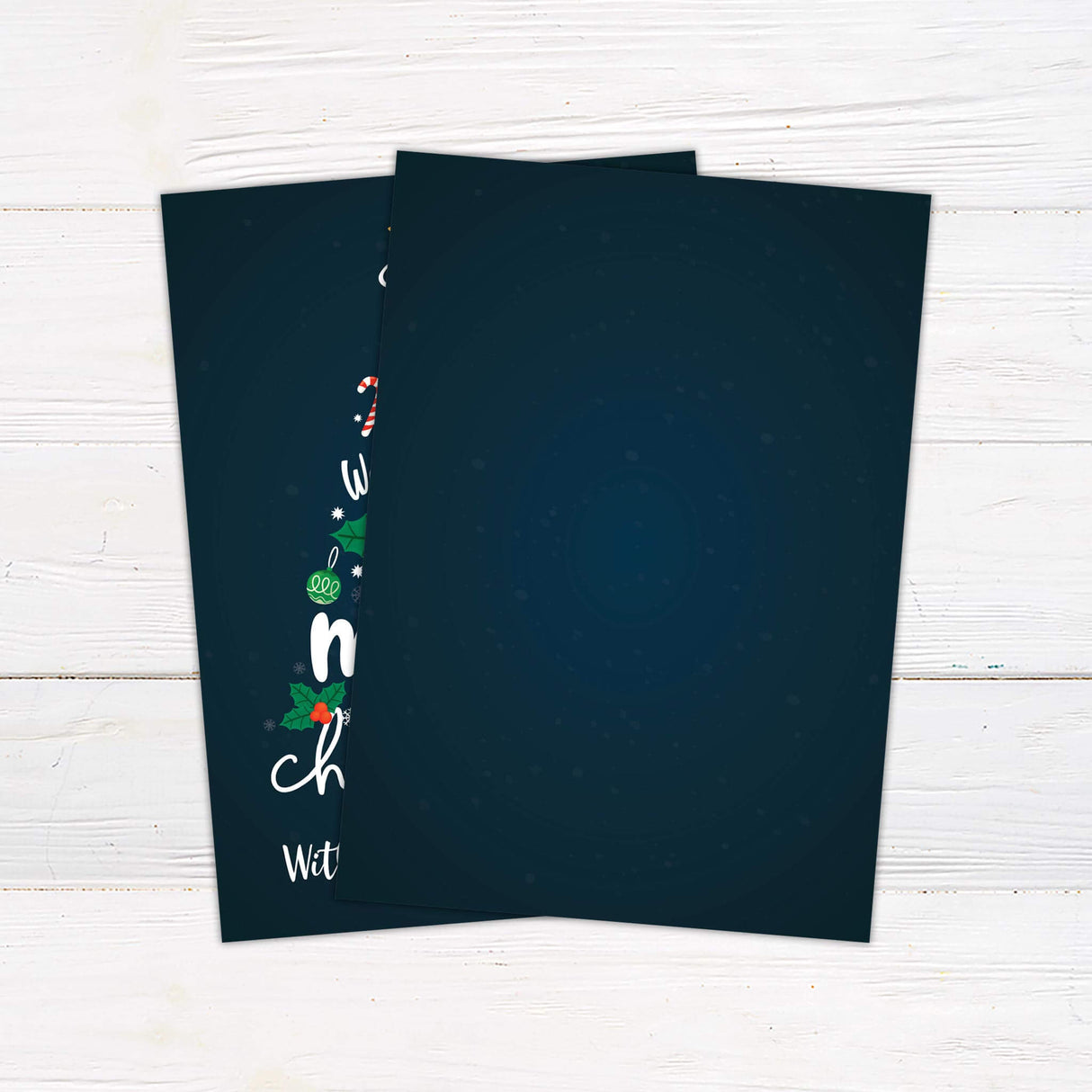 A Christmas card featuring a tree made of ornaments, holly, and snowflakes with the text “We Wish You a Merry Christmas.” The card is customizable with your family name. - back.