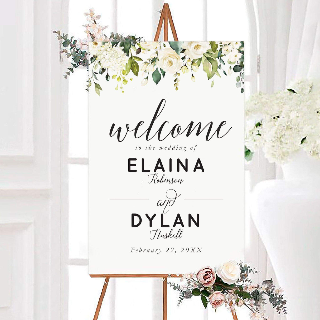 Personalized white roses wedding welcome sign with watercolor white roses, green leaves, and elegant black script typography. The botanical design features the couple’s names and wedding date on a clean white background.