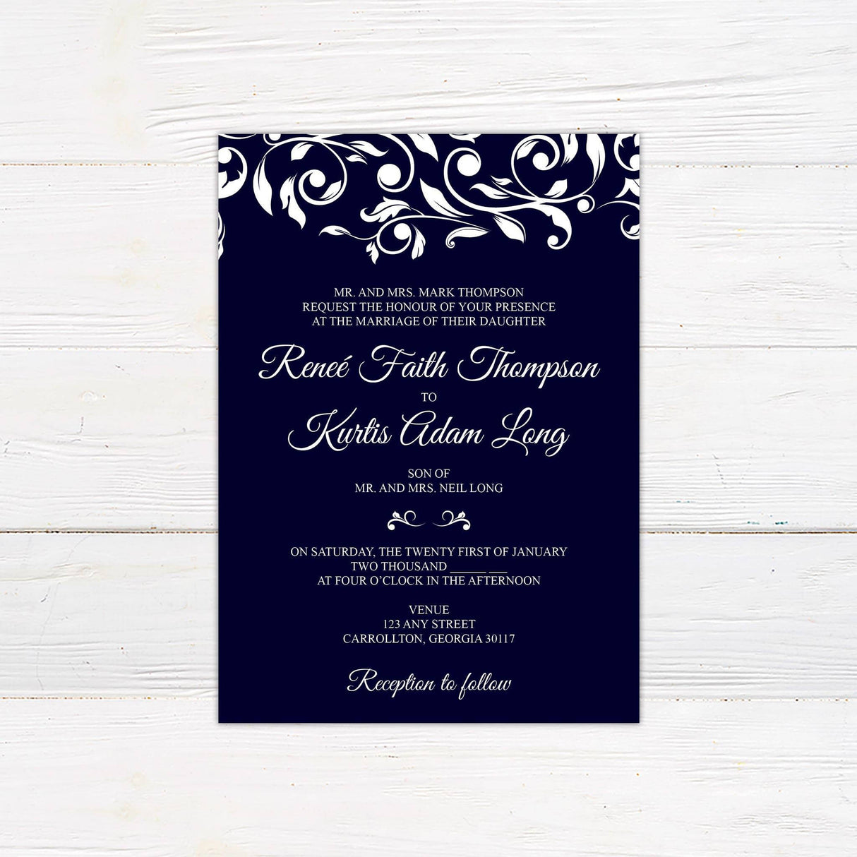 Navy wedding invitation with elegant white vine design and formal script and serif fonts.