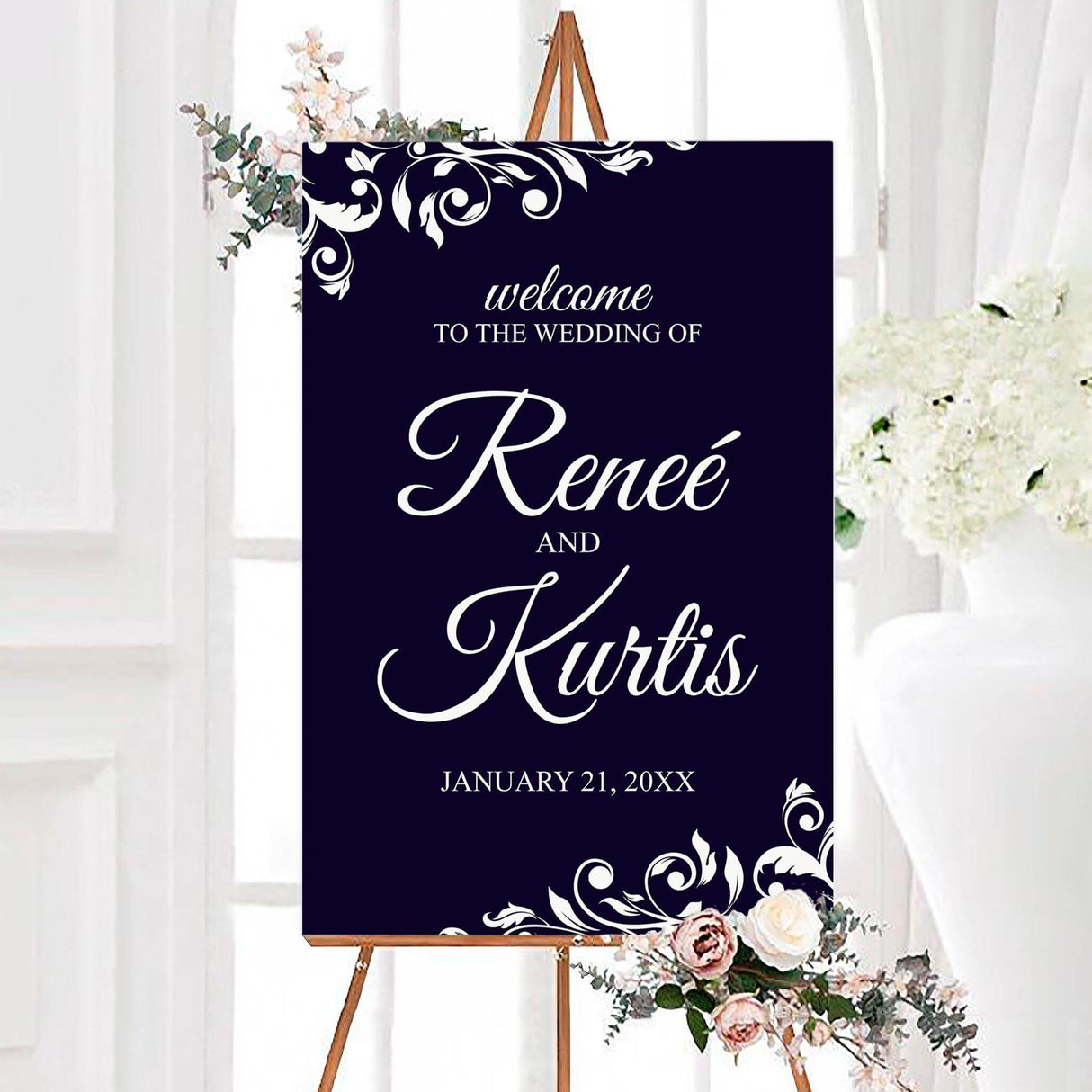 Large wedding welcome sign with white vine top border on a deep navy background.