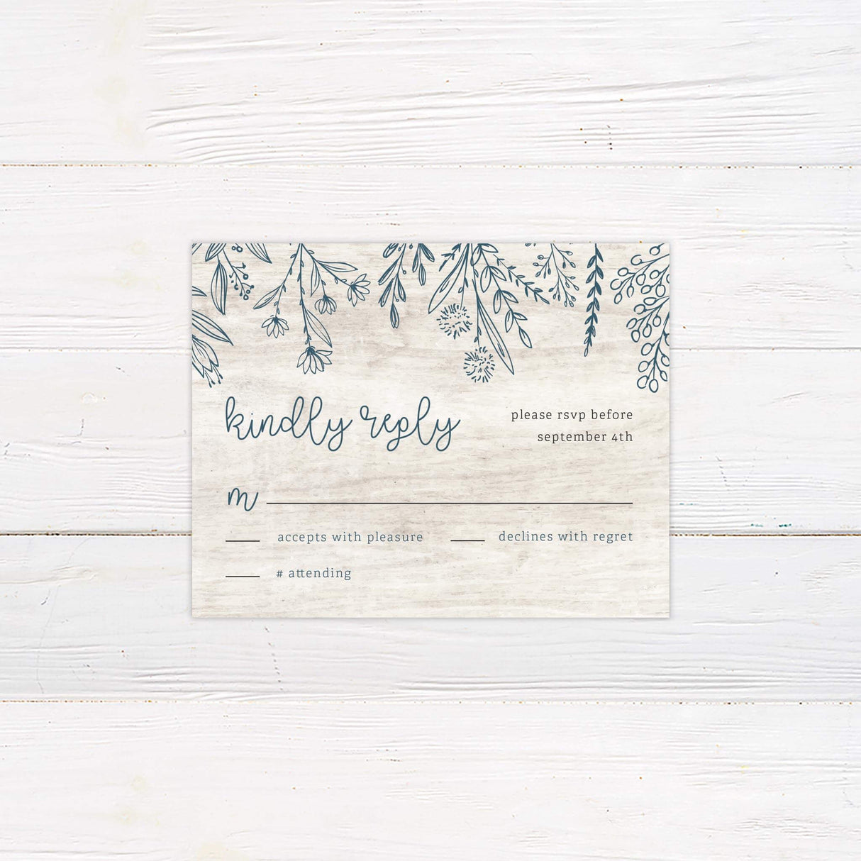 Coordinating RSVP card with matching botanical border and rustic woodgrain background.