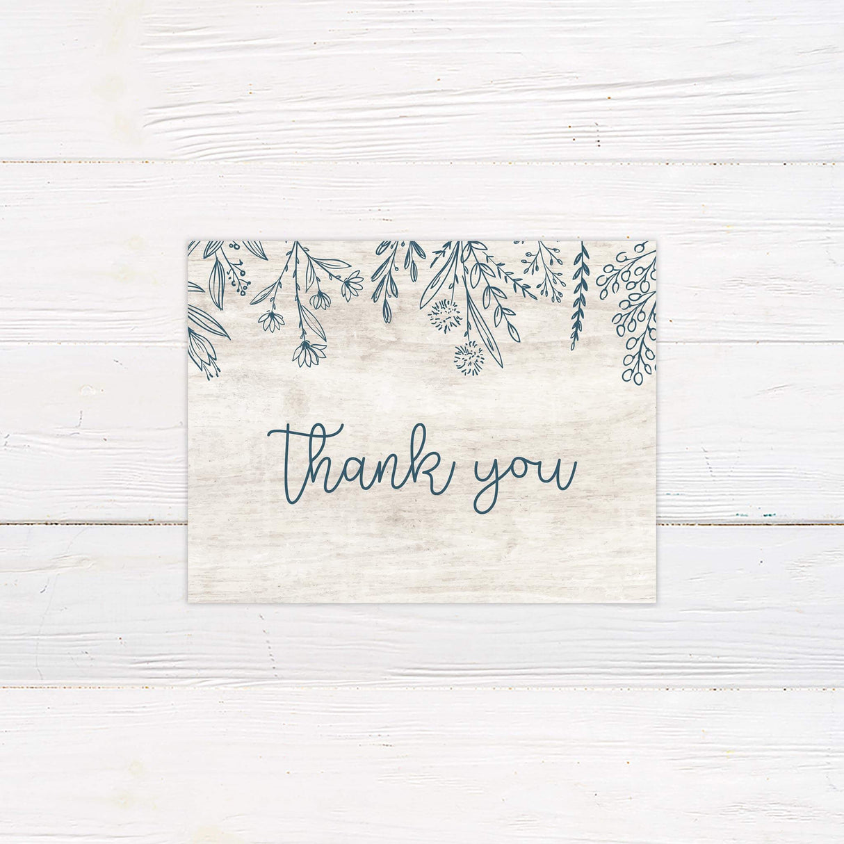 Matching thank you card with white wood background and floral border in blue-gray.