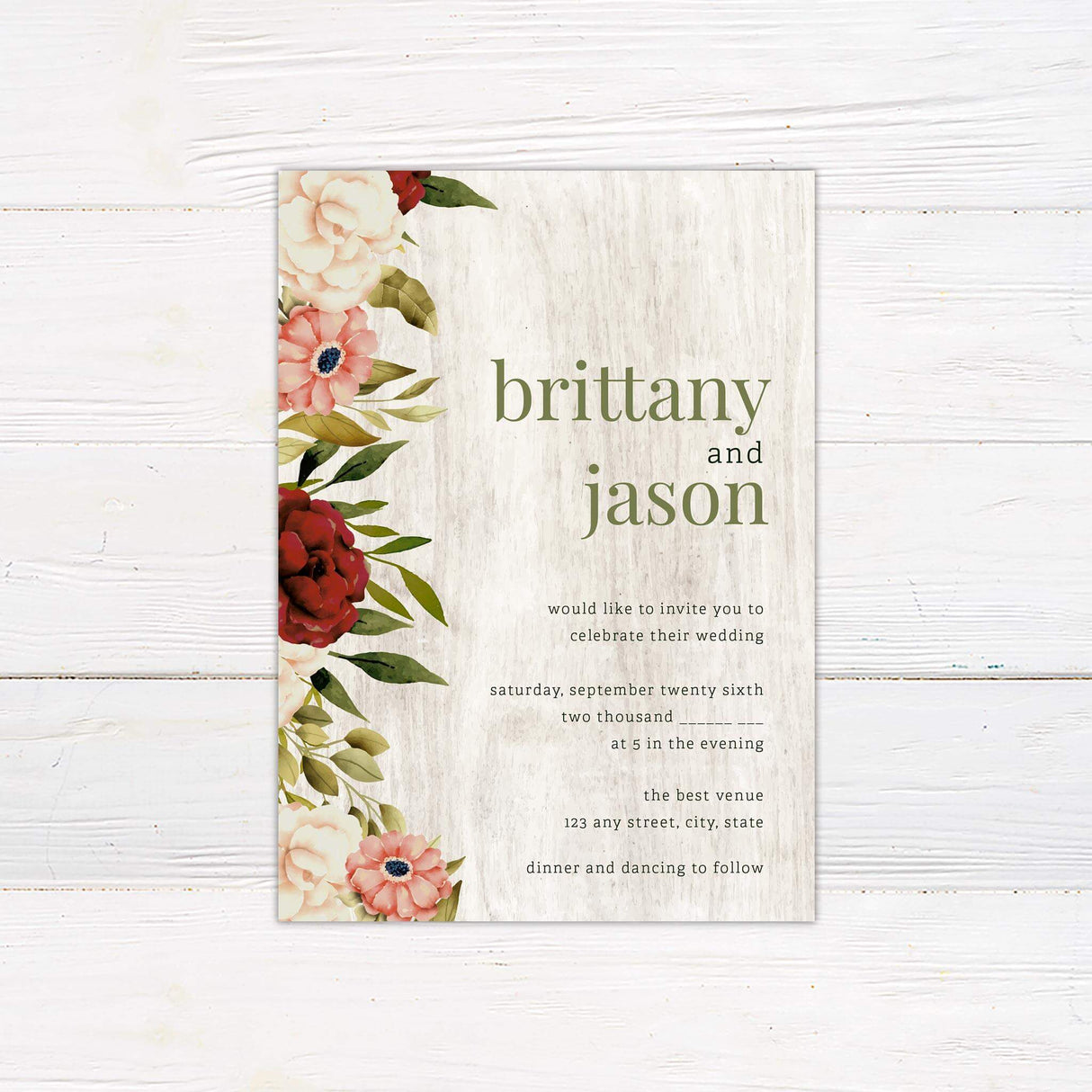 Rustic white wood wedding invitation with floral watercolor border in burgundy, blush, and cream, featuring elegant serif text in soft green and black.