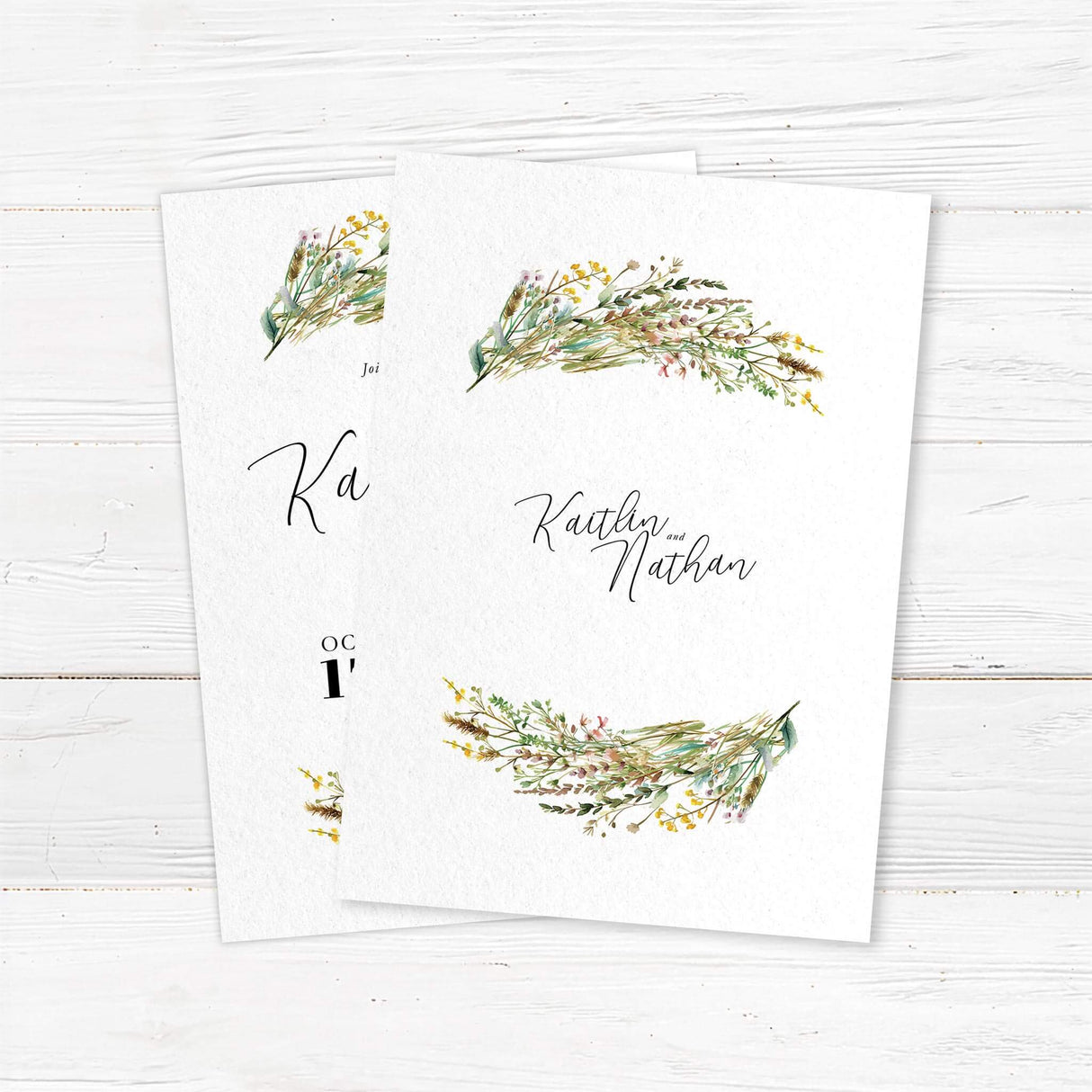 Romantic wedding invitation with watercolor wildflower bouquets at the top and bottom, featuring handwritten script for “Kaitlin and Nathan” and modern layout for date and location. back