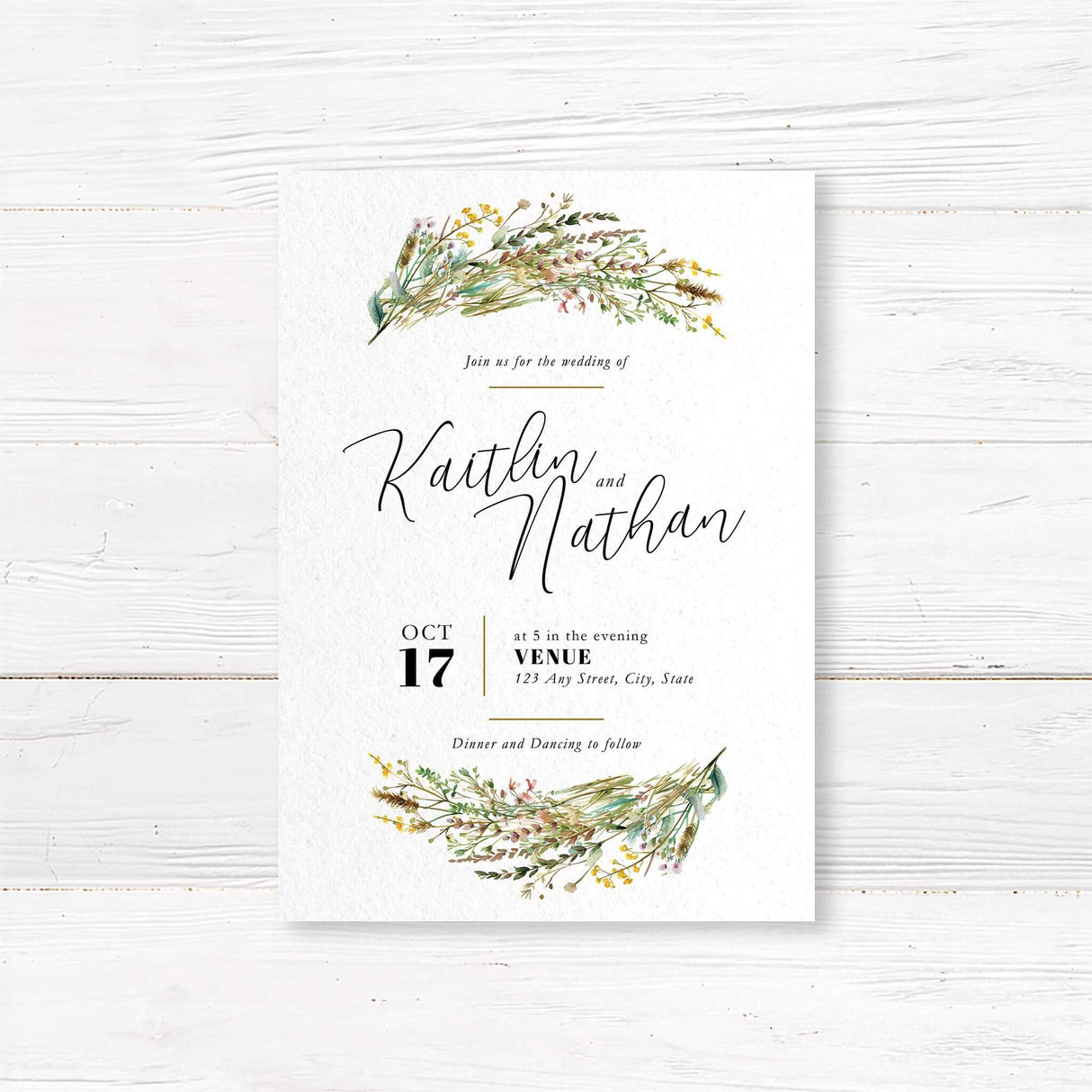 Romantic wedding invitation with watercolor wildflower bouquets at the top and bottom, featuring handwritten script for “Kaitlin and Nathan” and modern layout for date and location.