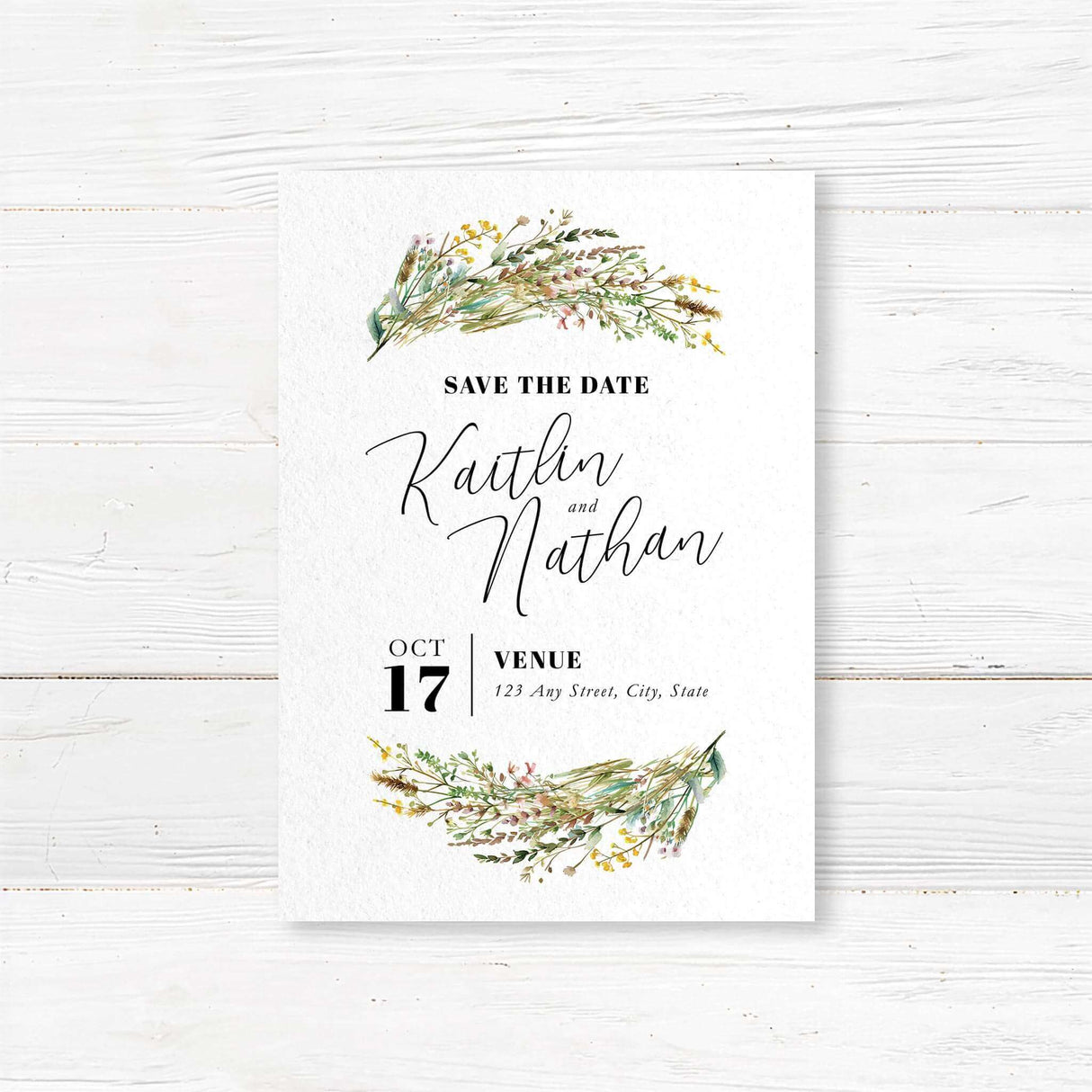Save the Date card with soft watercolor floral accents and modern typography. Printed on white cardstock, perfect for rustic and outdoor wedding themes.