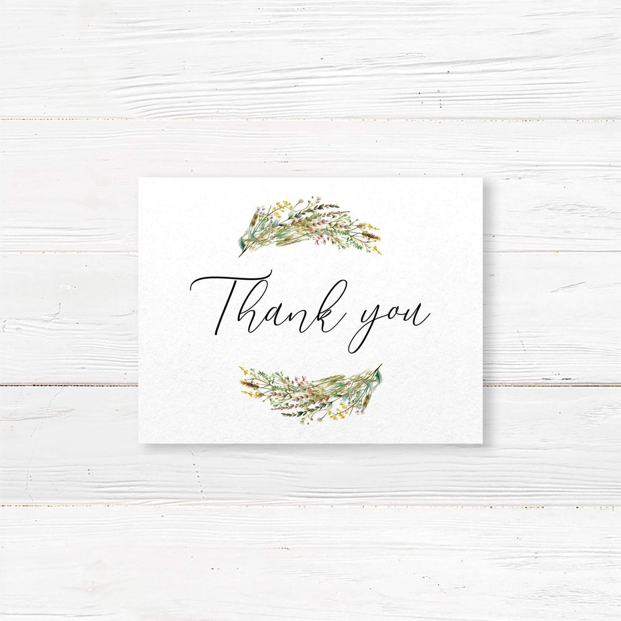 Thank you card featuring matching wildflower illustrations and simple black calligraphy text. Printed on white cardstock to coordinate with full suite.