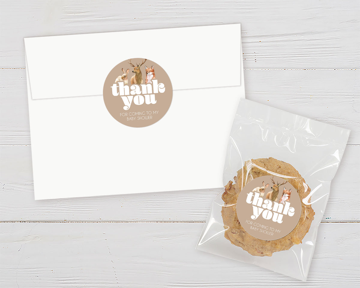 A wildlife adoption thank you favor sticker featuring painted illustrations of a rabbit, deer, and fox above the sticker's thank you message on a brown background.