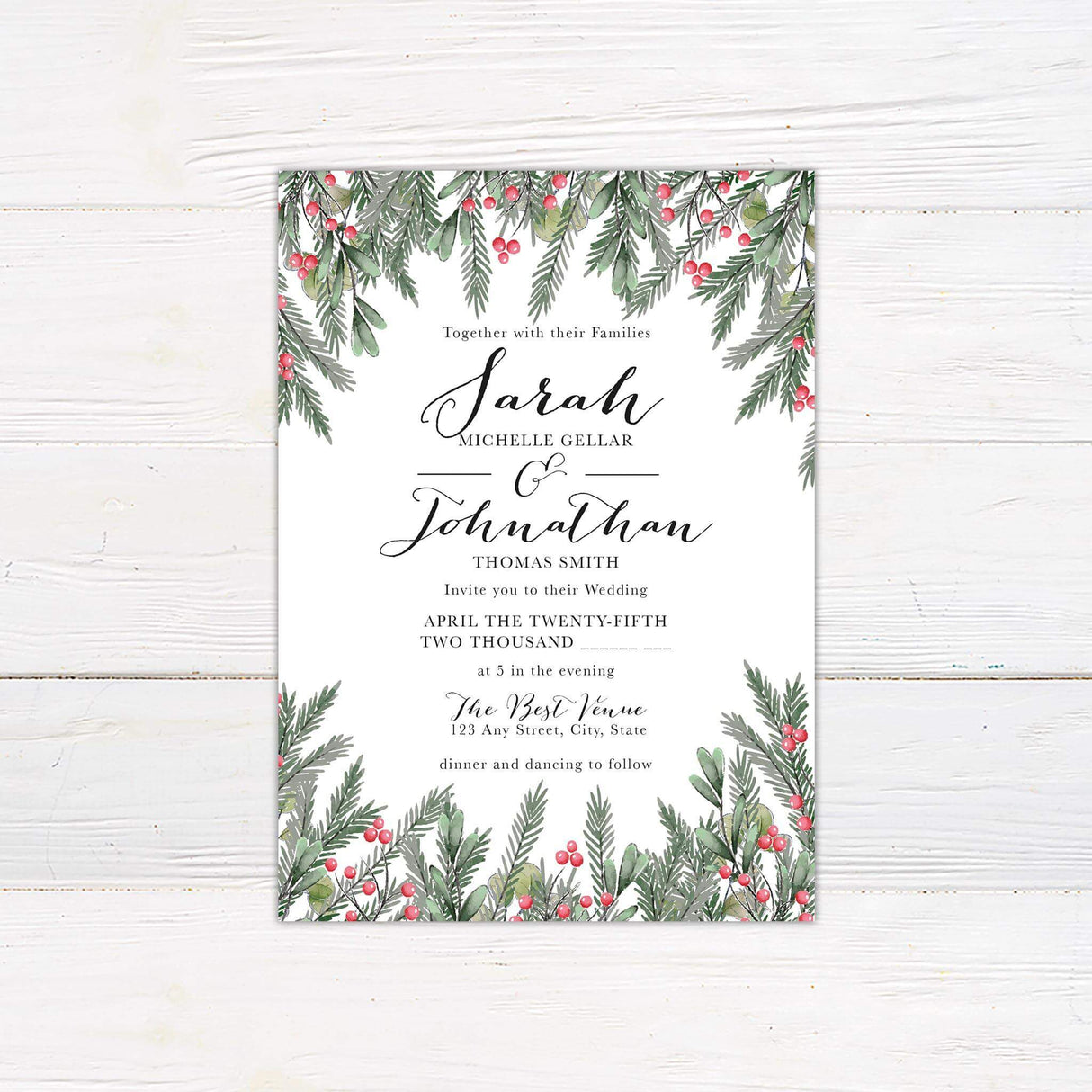 Wedding invitation featuring watercolor winter greenery and red berries with elegant calligraphy and serif fonts on white background.