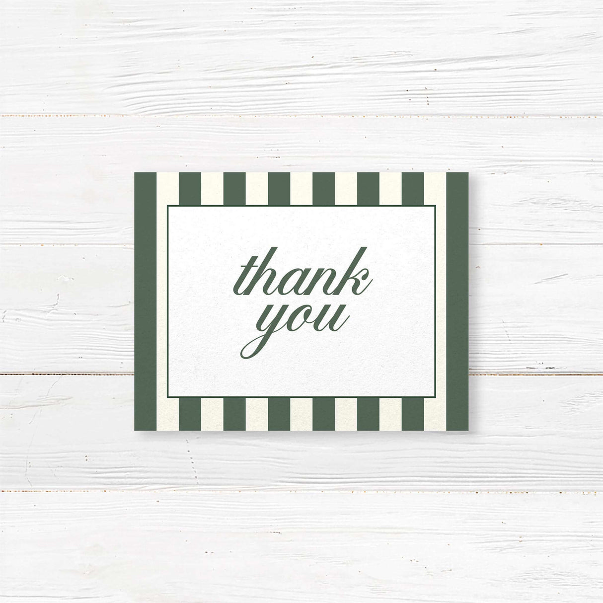 Wedding thank you card with botanical floral crest, vertical green and ivory stripes, and classic fonts for a printed card matching the Winter Crest wedding stationery suite.