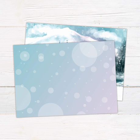 Watercolor winter holiday card with snowy mountain scene, pine trees, and red cabin reading "Merry Christmas and a Happy New Year" in elegant script. back side