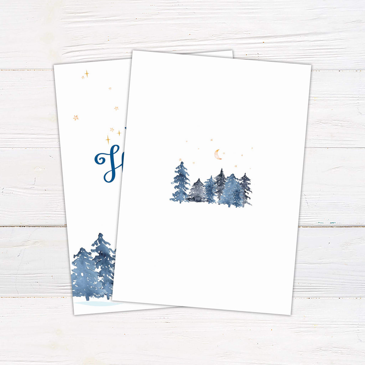 A holiday card with a snowy winter forest and a cozy house beneath a starry night sky. Customizable with family name and seasonal message. - back.