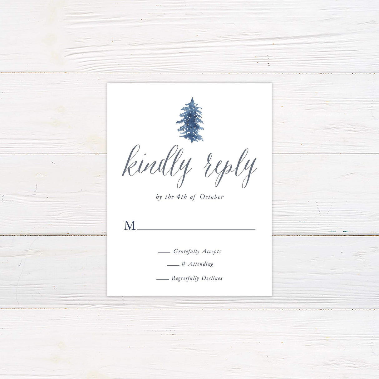 Wedding RSVP card with snowy watercolor pine trees in blue and gray tones and elegant calligraphy.