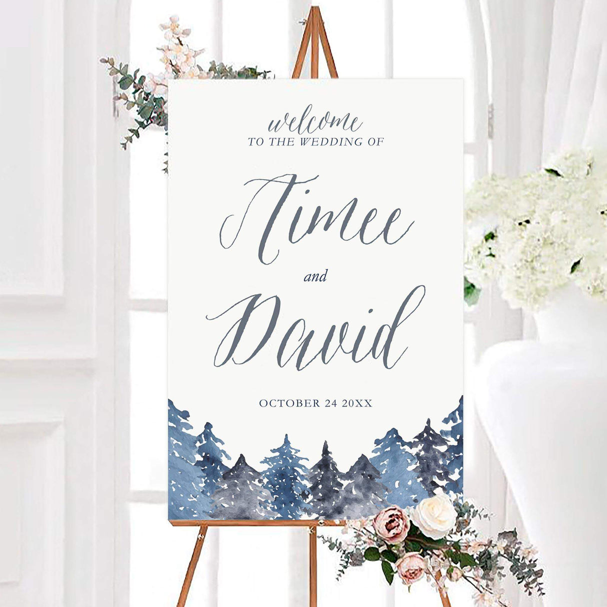 Welcome sign with snowy watercolor pine trees in blue and gray tones and elegant calligraphy.