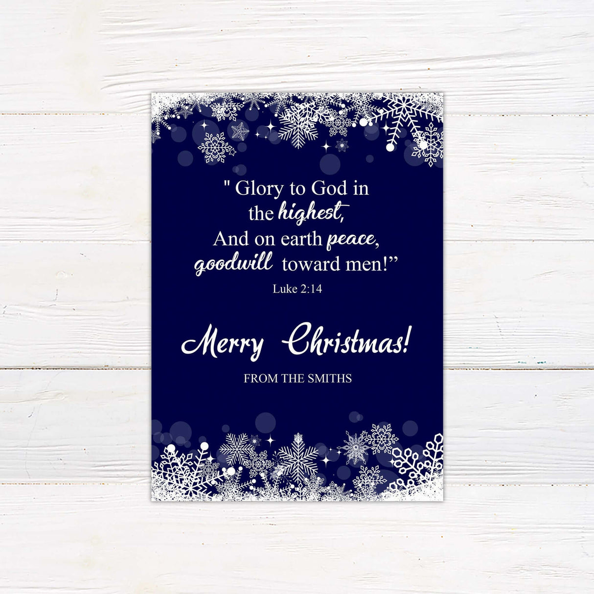 A navy Christmas card with white snowflake accents and customizable text. Personalized with family name, year, and holiday message for a unique design.