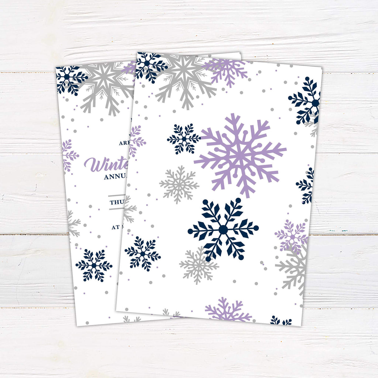 Festive invitation design with large snowflakes and soft colors invites guests to a Winter Wonderland-themed Christmas party. The layout is elegant and includes party details with decorative purple, navy, and taupe snowflakes scattered around. - back side.
