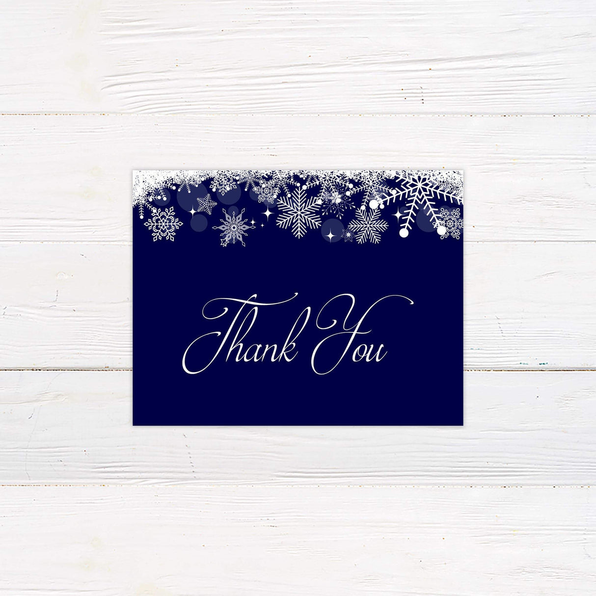 Navy blue thank you card with white snowflakes and elegant script for a winter theme
