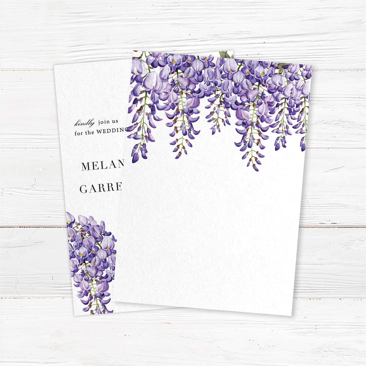 Wedding invitation back with watercolor wisteria flowers in soft purple and lavender tones, paired with elegant serif fonts on white textured cardstock. Romantic floral design.