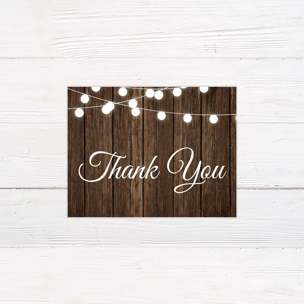 Rustic thank you card with string lights and wood background from the wedding suite.