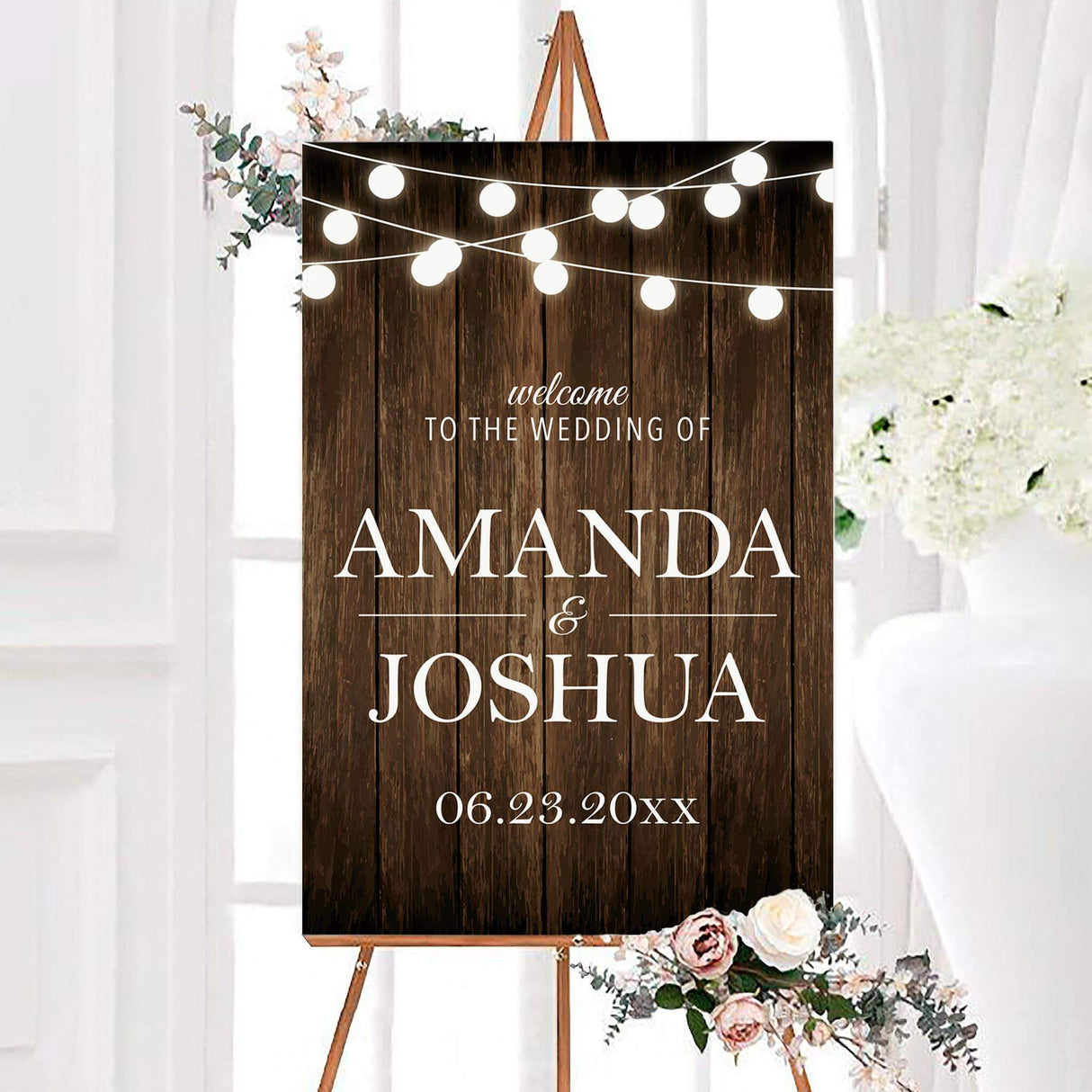 Wooden welcome sign with white text and glowing string lights, matching rustic design.