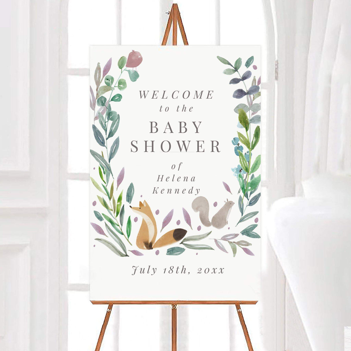 Woodland-themed baby shower welcome sign featuring watercolor greenery, a fox, and a squirrel, with elegant typography on a neutral background.