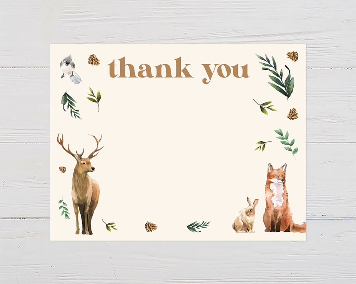A woodland wildlife thank you card featuring a illustrated bird, rabbit, fox, and deer as well as forest foliage on a beige background with plenty of space to leave a message to all your guest.