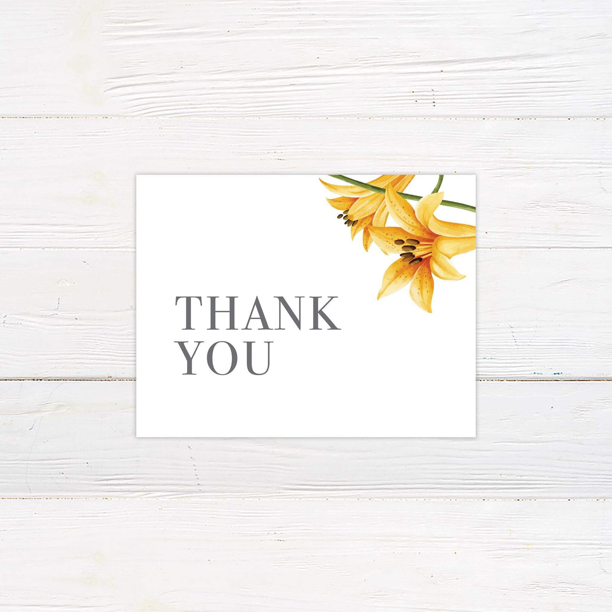 Elegant printed thank you card with yellow lily floral design, featuring classic typography and soft botanical accents for a romantic wedding theme.